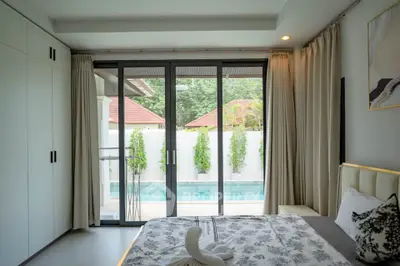 Luxurious bedroom with pool view and elegant decor