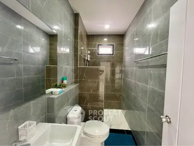 Modern bathroom with sleek gray tiles and compact design