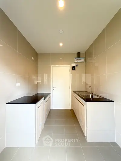 Modern kitchen with sleek countertops and ample storage space