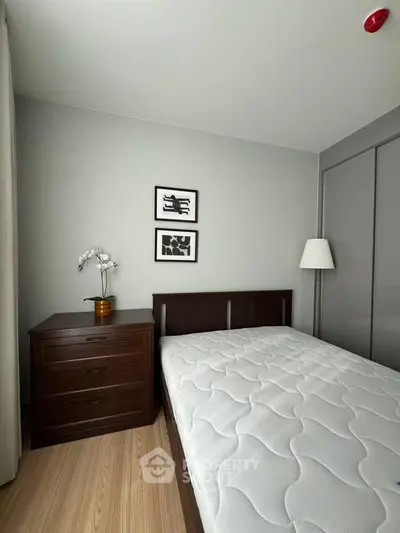 Cozy bedroom with modern decor and comfortable bed in stylish apartment.