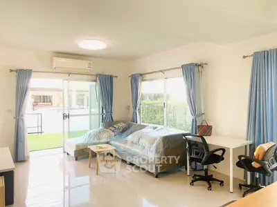 Spacious living room with modern furniture and large windows in a bright home