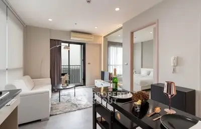 Modern open-plan living room with elegant decor and balcony access