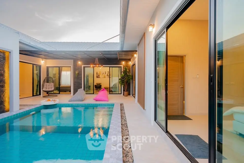 Luxurious modern villa with private pool and stylish outdoor seating area.