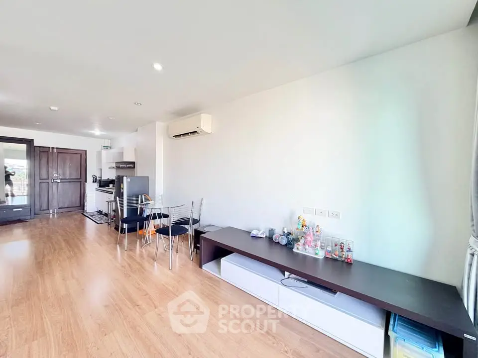Spacious modern living room with wooden flooring and minimalist decor