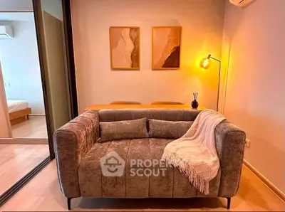 Cozy living room with plush sofa and warm lighting, perfect for relaxation.