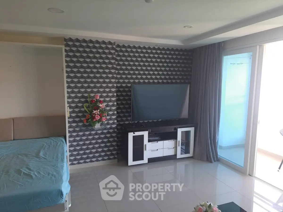 Modern living room with stylish geometric wallpaper and large TV