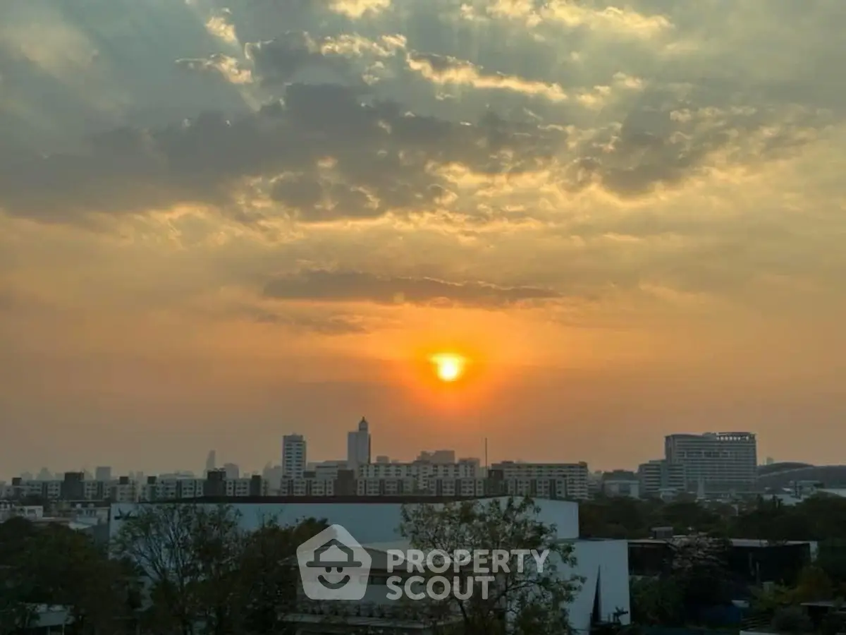 Stunning cityscape view with sunset over urban skyline, perfect for real estate allure.