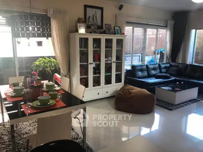 Spacious living room with modern dining area and cozy seating arrangement.