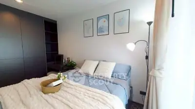 Cozy bedroom with modern decor and soft lighting, perfect for relaxation.