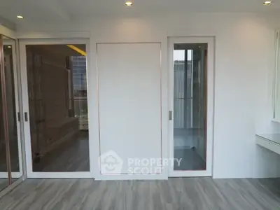 Modern interior with sliding glass doors and sleek flooring in a bright apartment.