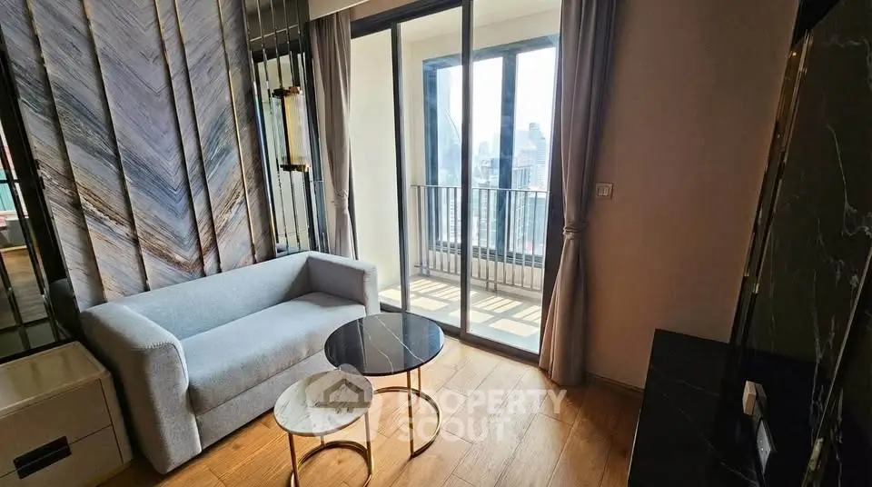 Modern living room with stylish decor and city view balcony in luxury apartment.