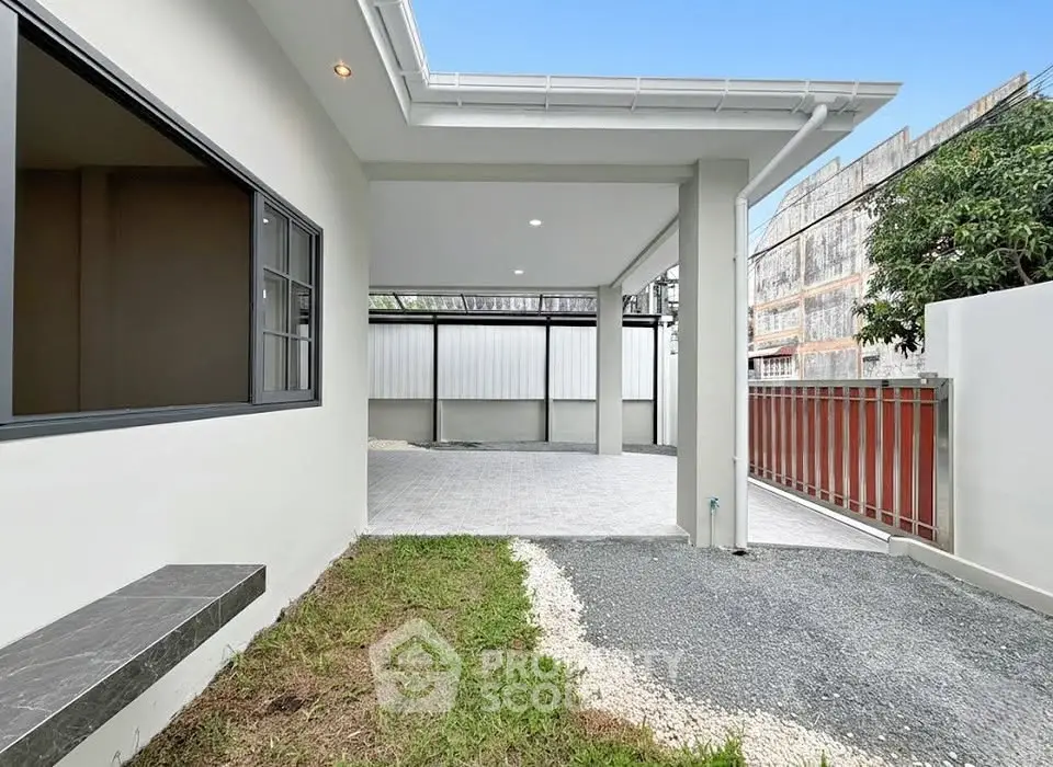 Modern house exterior with spacious driveway and sleek design