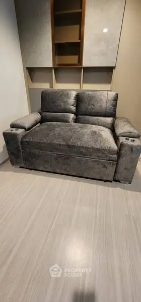 Modern living room with plush gray sofa and sleek flooring