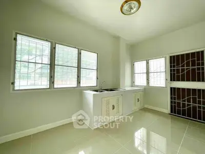 Spacious kitchen with large windows and modern sink area