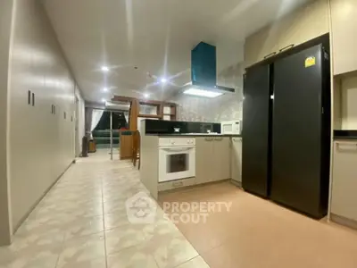 Spacious modern kitchen with sleek appliances and open layout, perfect for culinary enthusiasts.
