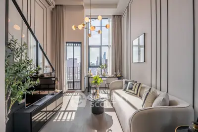 Luxurious modern living room with high ceilings and city view, featuring elegant decor and ample natural light.