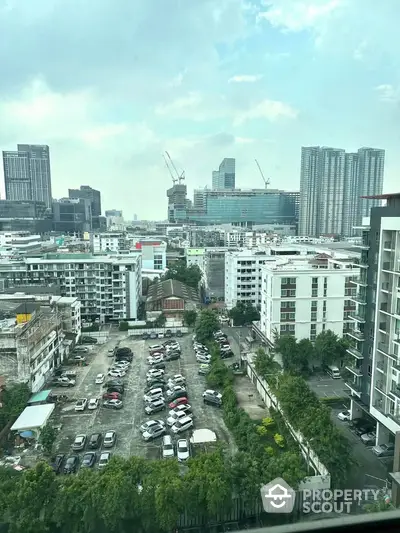 Stunning cityscape view from high-rise building with ample parking space and modern architecture.