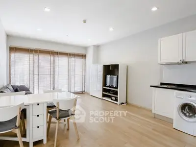 Modern open-plan living room with natural light and wooden flooring