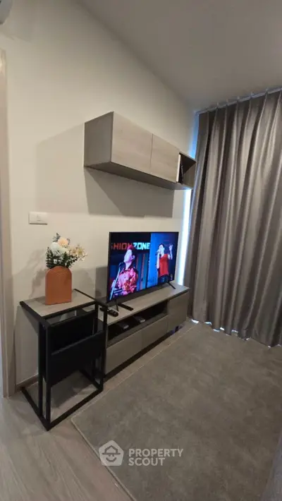 Modern living room with stylish TV setup and elegant curtains