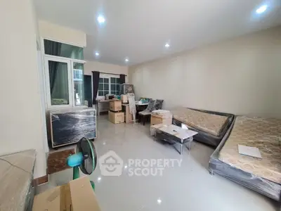 Spacious living room with modern furniture and large windows for natural light.