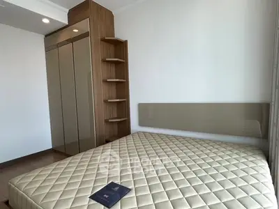 Modern bedroom with sleek wardrobe and stylish shelving in a contemporary apartment.