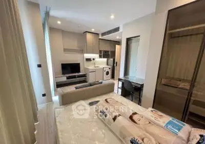 Modern studio apartment with open layout, featuring a cozy living area, compact kitchen, and stylish furnishings.