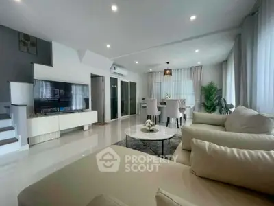 Spacious modern living room with elegant decor and ample natural light, perfect for relaxation and entertainment.