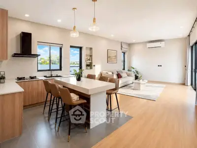 Spacious open-plan kitchen and living room with modern design and natural light.