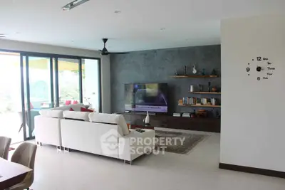 Spacious modern living room with large windows and stylish decor