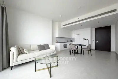 Modern minimalist living room with open kitchen and stylish furniture