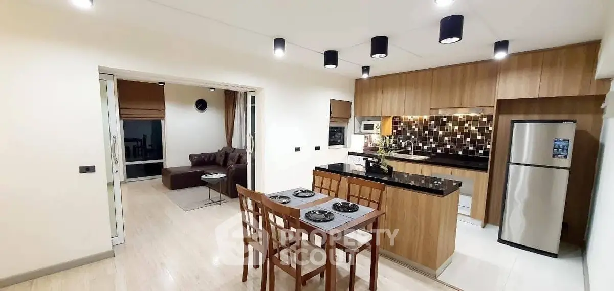 Modern open kitchen and living area with stylish decor and appliances