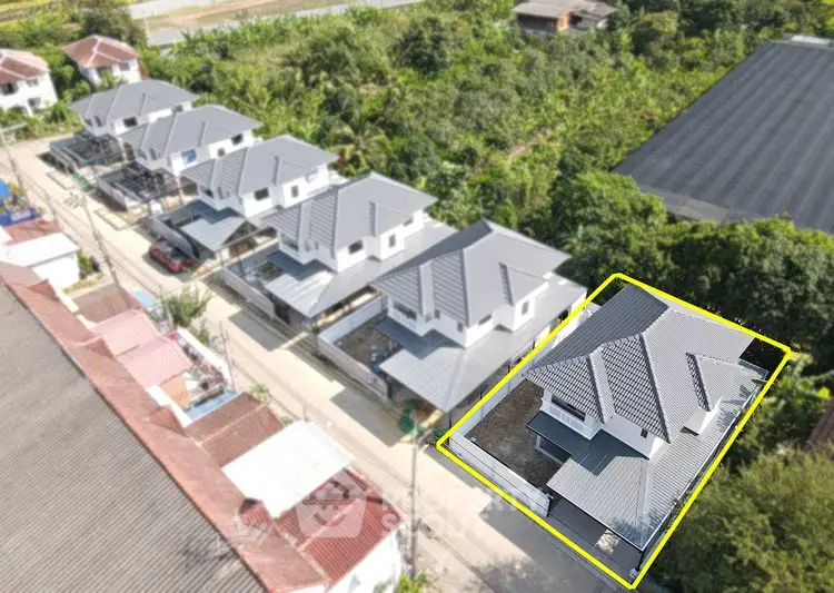 Aerial view of modern residential houses with grey roofs in a suburban neighborhood.