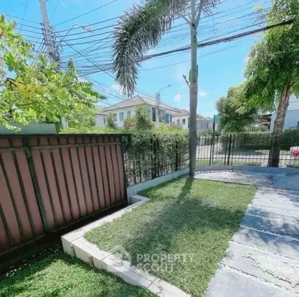 Charming garden view with lush greenery and modern fencing in a serene neighborhood.