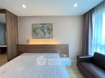 Modern bedroom with world map decor, cozy lighting, and sleek furniture design.