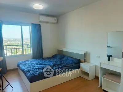 Spacious bedroom with scenic view and modern furnishings