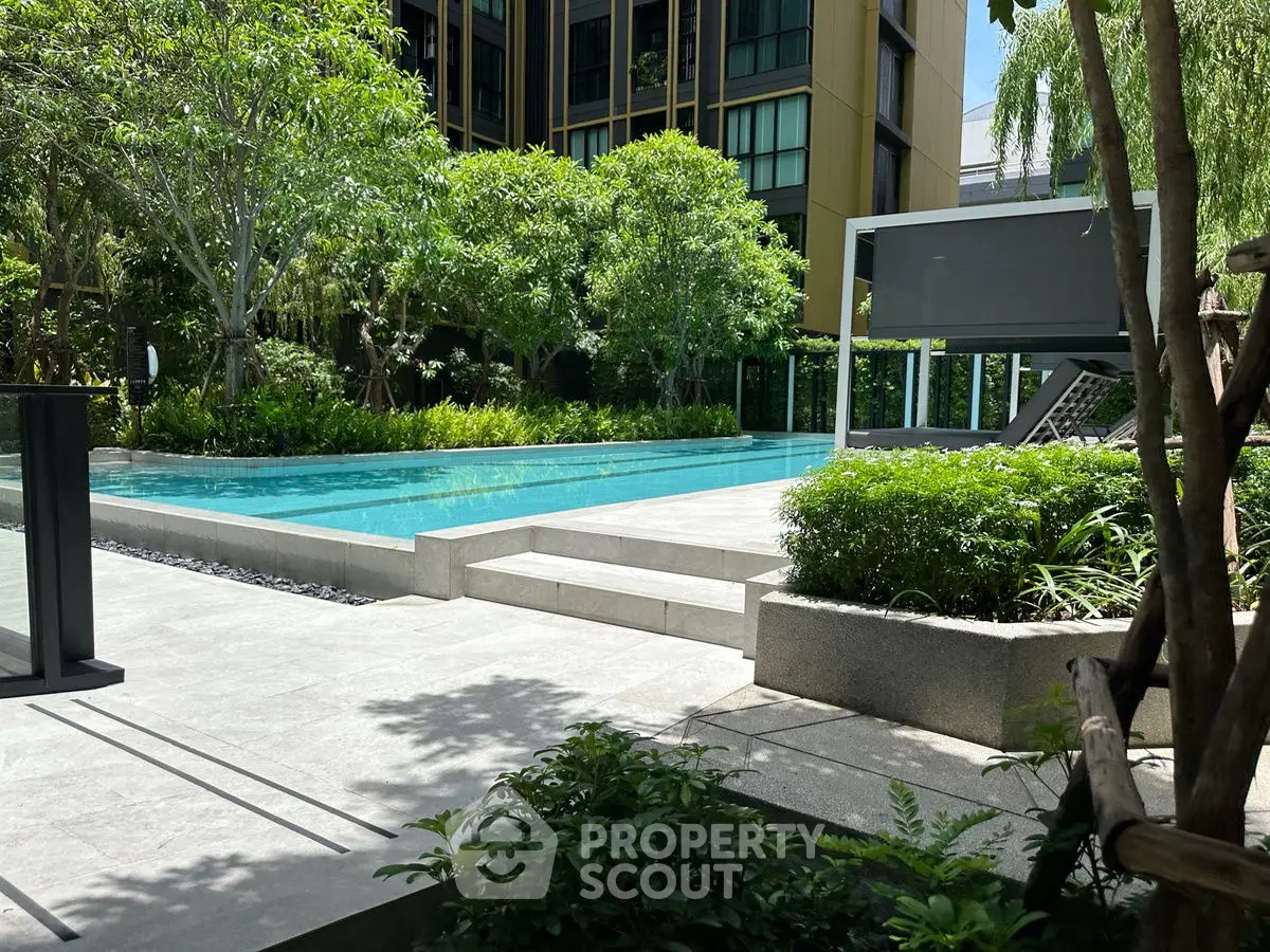 Luxurious outdoor pool area with lush greenery and modern design