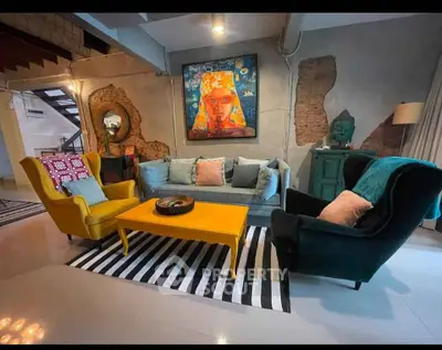 Stylish living room with vibrant furniture and eclectic decor in modern home