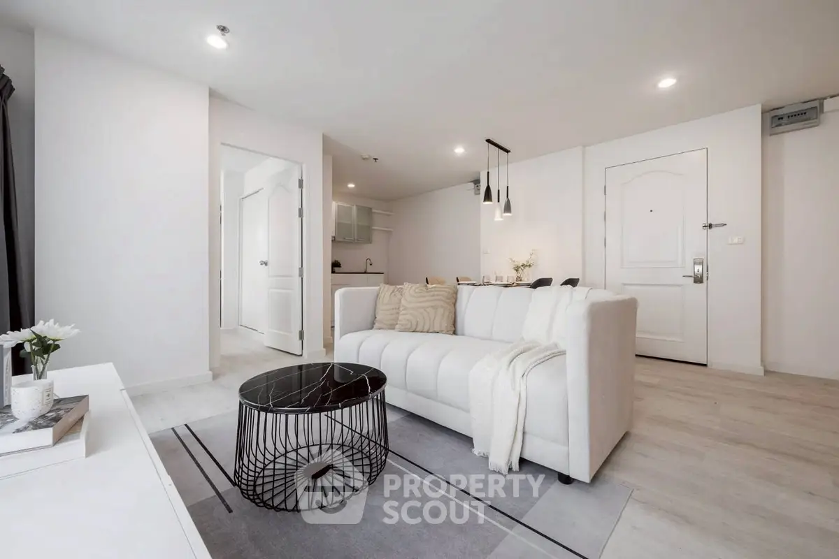 Modern living room with elegant decor and open kitchen layout in a stylish apartment.