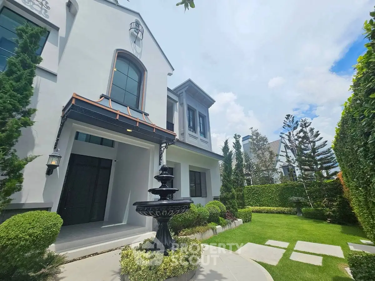 Elegant modern house exterior with lush garden and fountain