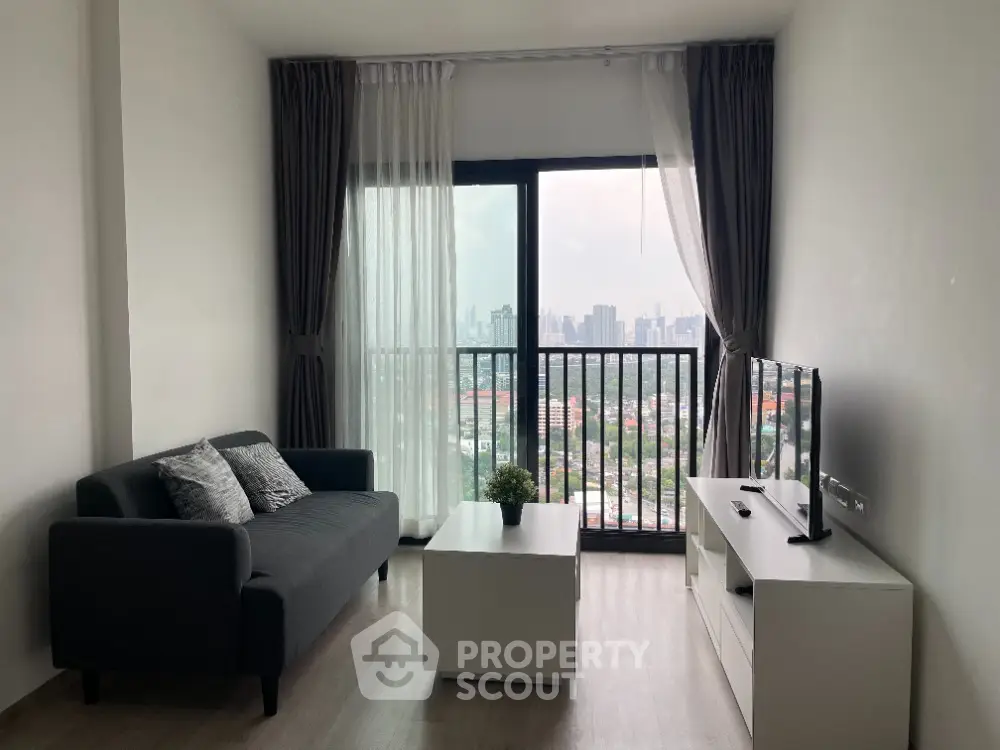 Modern living room with city view, stylish sofa, and sleek furniture