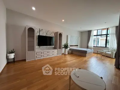 Spacious modern living room with wooden flooring and stylish decor