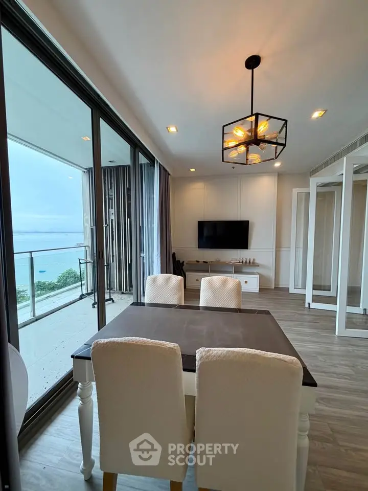Modern living room with ocean view and elegant dining area in luxury apartment