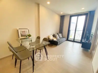 Modern living room with glass dining table and city view, perfect for urban living.