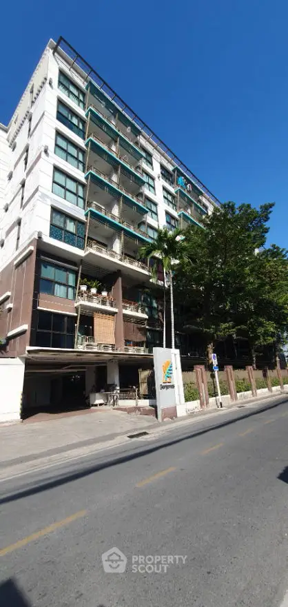 Modern urban building exterior with unique architectural design and street view.