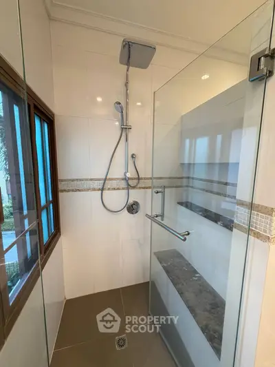 Modern bathroom with glass shower enclosure and sleek fixtures