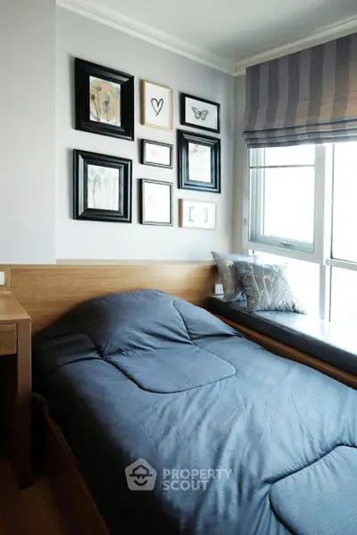 Cozy bedroom with stylish decor and large window for natural light