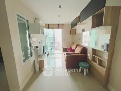 Modern living room with sleek furniture and balcony view in a stylish apartment.