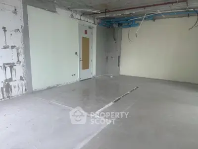 Unfinished interior space with concrete floors and exposed wiring, ideal for customization.