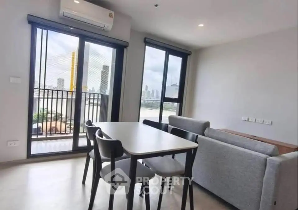 Modern living room with dining area and balcony view in city apartment