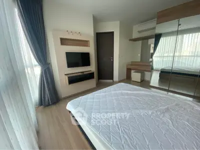 Modern bedroom with large mirrored wardrobe and natural light